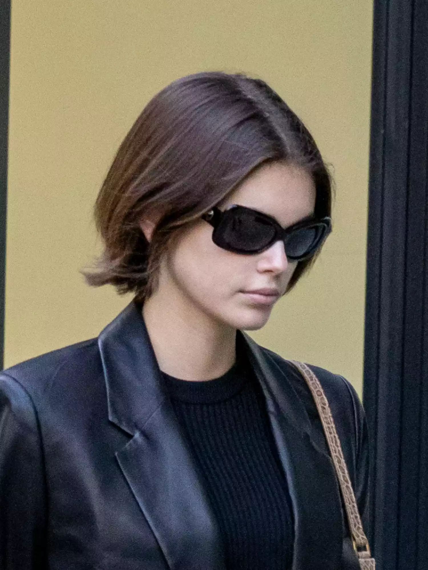 Kaia Gerber wearing black sporty sunglasses